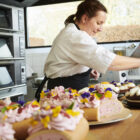 konditor pynter kager med blomster i bageriet på munkebjerg hotel